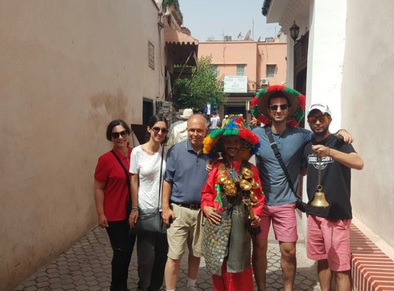 Travelers on a Morocco custom tour meeting water sellers