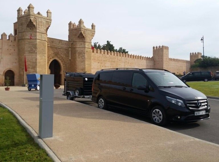 Private driver van at a kasbah gate on a Morocco tour